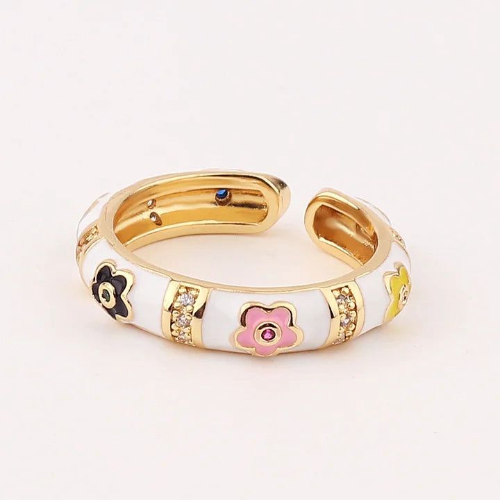 Gold and white ring with floral designs on a light background
